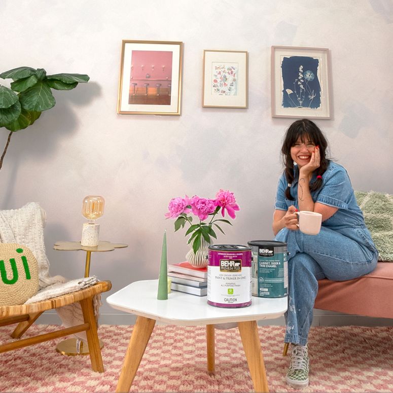 DIY expert Maca Atencio sitting in living room with limewash wall effect.