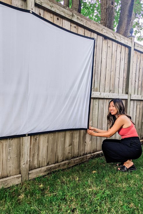 DIY creator Natalie Ho setting up a movie screen outdoors
