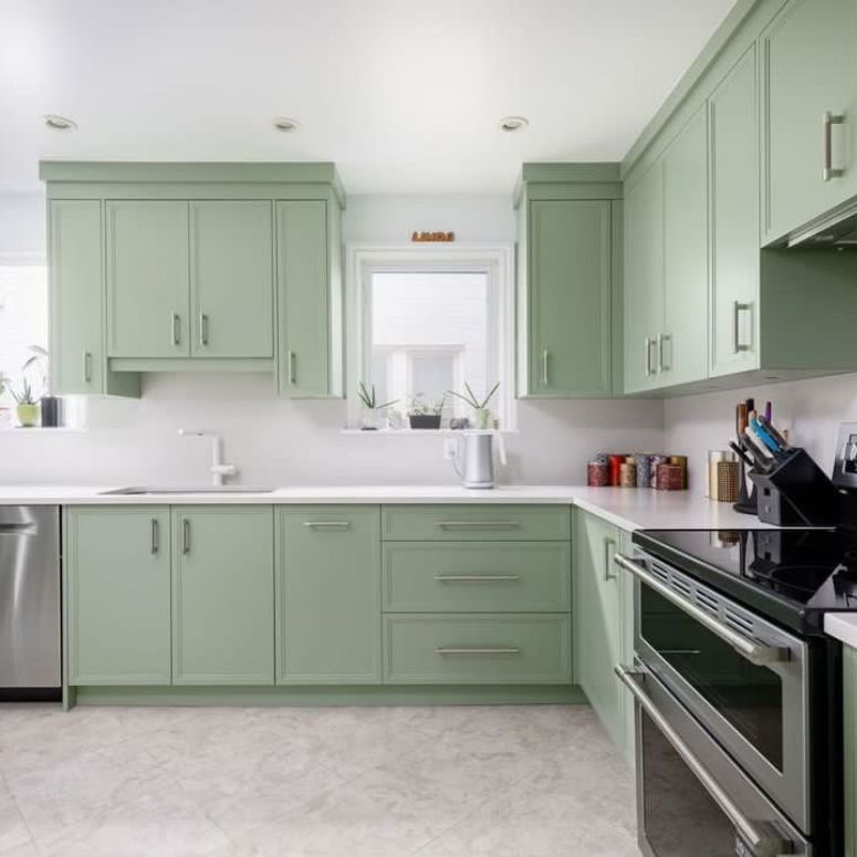 Light green kitchen with white countertops