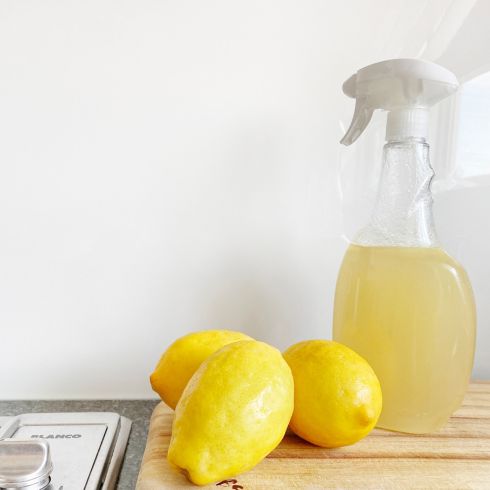 Natural stain remover made with lemon in plastic spray bottle