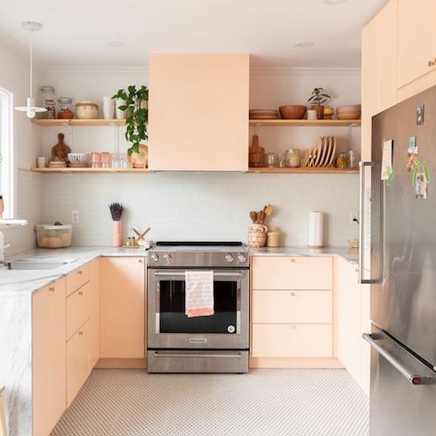 A fully renovated kitchen in a Montreal bungalow with pink cabinets and quartz countertop designed by Lauren Kolyn and featured on HGTV Canada