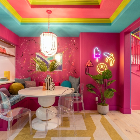 Another look at the dining area, with a splatter wall backsplash and pop art neon lights