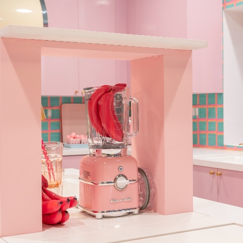 A pink reto SMEG toaster in the Barbie Dreamhouse kitchen