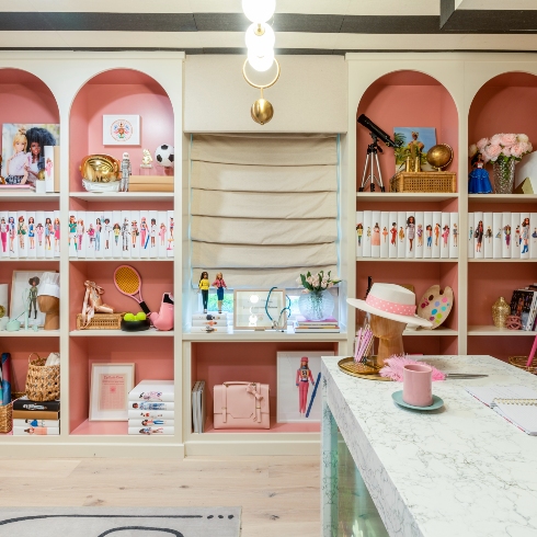 The pink arched shelving in the Barbie Dreamhouse office