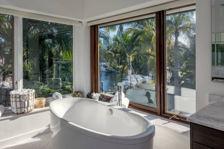 A bathroom with a large soaker tub and floor-to-ceiling windows