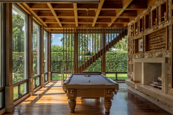 A games room with billiards table and large floor-to-ceiling windows