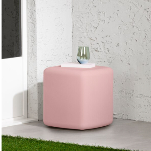 A pink covered side table and seating combo