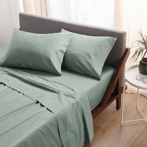 Sage green bedding on modern bed