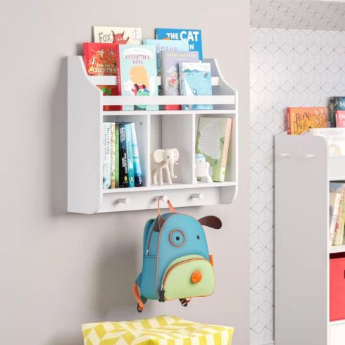 Kids white wall shelf with cubbies and a book rack.