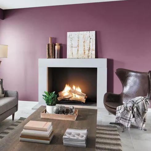 Modern living room with fireplace and raspberry purple walls