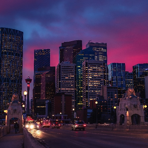 The Calgary skyline at night with a view of the tower and the Centre Street Bridge lions