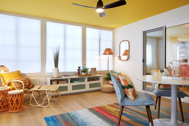 warm inviting sunroom of the Beachside Abode with a pop of colour on the ceiling
