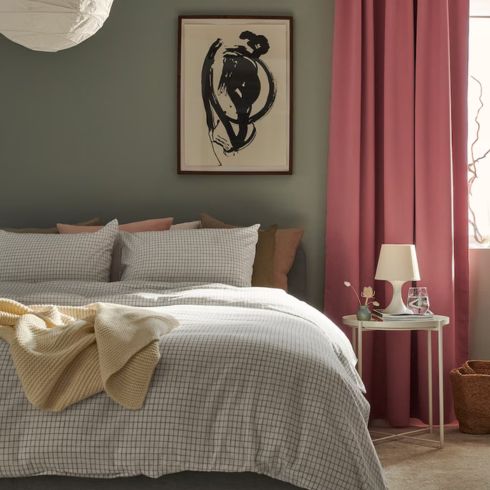 Bedroom with sage green walls and checkered bed sheets