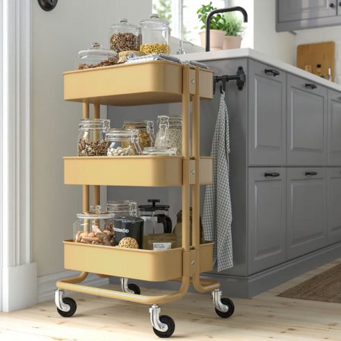 Yellow utility cart with wheels in kitchen