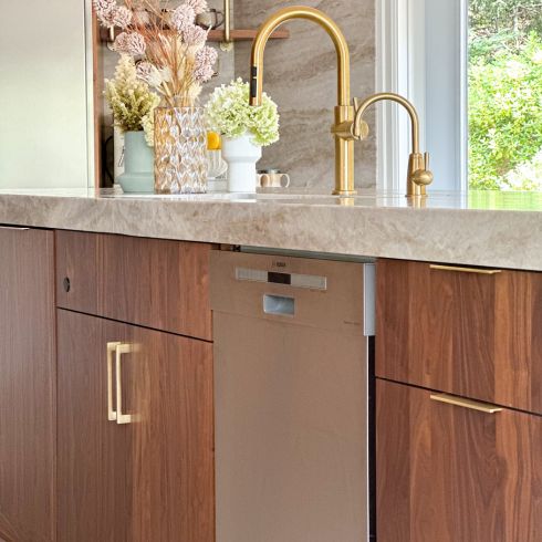 Walnut kitchen with brass hardware and faucet
