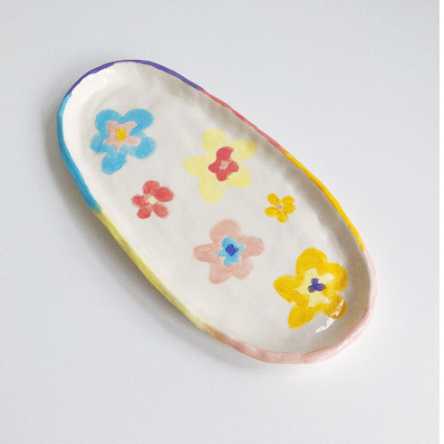 A ceramic tray with painted flowers