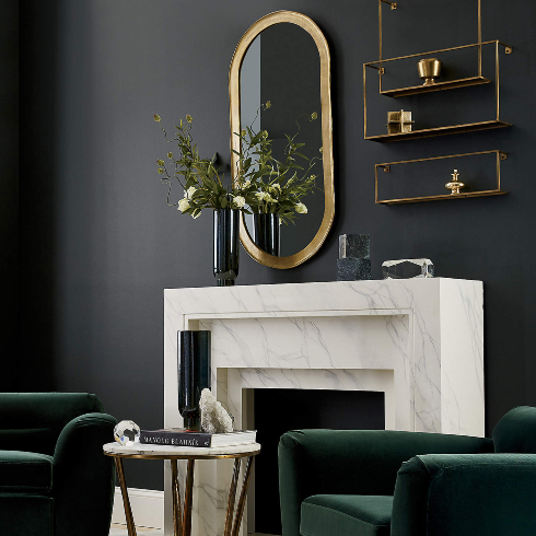 A dark modern living room with gold shelving and mirrors