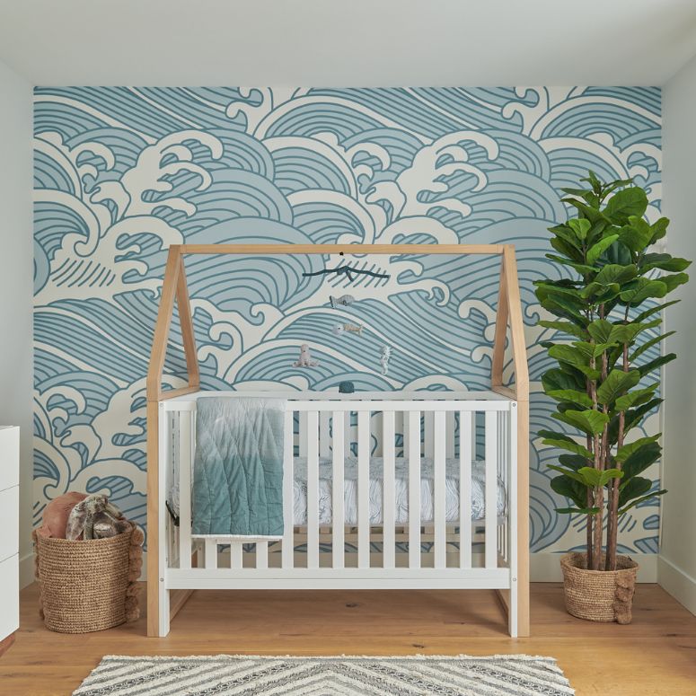Sea-themed nursery with wave wallpaper