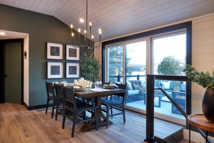 The well defined dining area with a black, white, and olive palette.