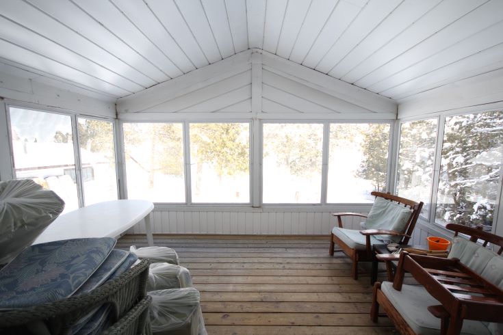 A sparse and lackluster screened in porch