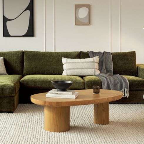 Green couch with round coffee table