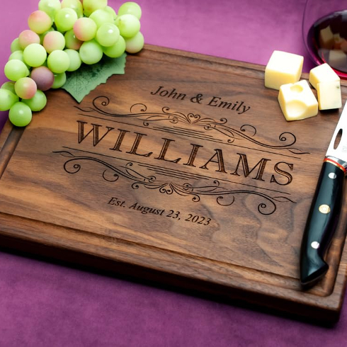 A dark wood cutting board engraved with a last name