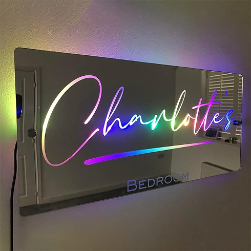 A mirror that reads Charlotte's room in multicoloured lights