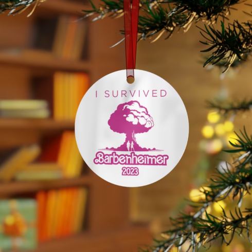 white ornament with a pink cloud with text saying I survived Barbenheimer 2023