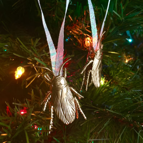 A cockroach ornament on a Christmas tree