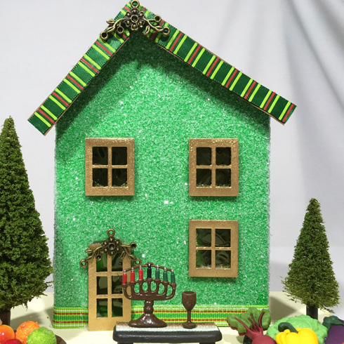 Canadian holiday decorations - A glitter miniature house with Kwanzaa decor