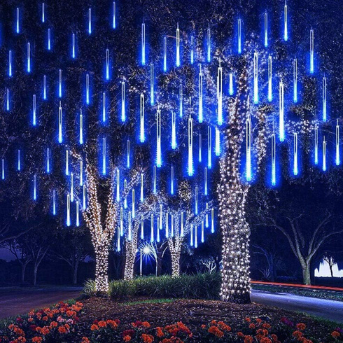 Outdoor Holiday Lighting Trends - A large home in the background with a display of blue meteor string lights