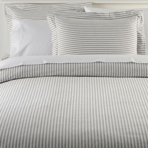 L.L.Bean’s Ultrasoft Comfort Flannel Comforter and pillow cases in Feldspar grey stripe sit on a white bed with white sheets and pillow cases