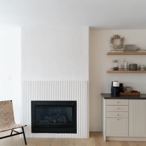White reeded fireplace in modern room