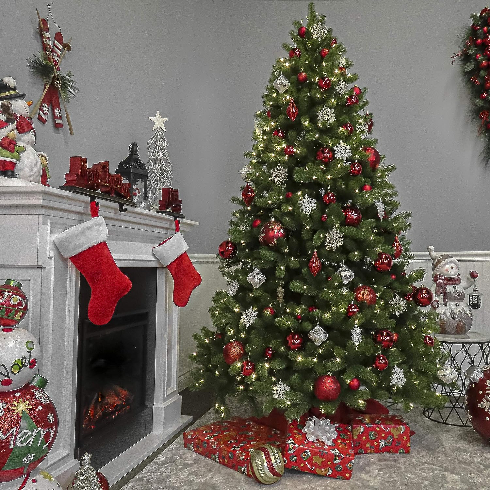 A classic Douglas fir artificial Christmas tree decorated with white and red decorations