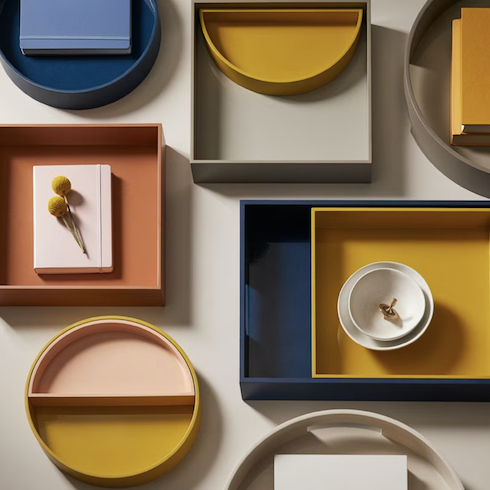 Product shot of multiple colourful OUI trays from Chapters Indigo for HGTV.ca Toy Organizer gallery