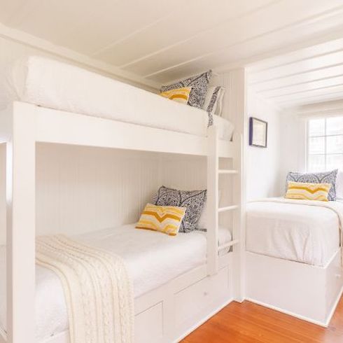Celebrity homes - Coastal inspired white bedroom with three built-in bunk beds feature in Ashton Kutcher and Mila Kunis's Santa Barbara beach house