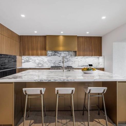 Celebrity homes - Cher's stunning chef’s kitchen has Brazilian oak flooring that’s continued throughout the house and connects to the bar room off the side with a beautiful large marble counter island with top-of-the-line appliances