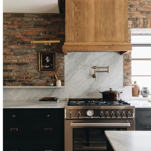 Kitchen with brick wall and marble elements