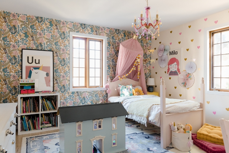 A child's room with vibrant wallpaper.
