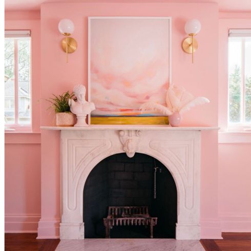 Pink fireplace in room with pink walls