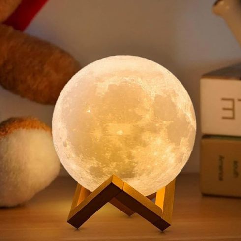 Amazon's Glowing Moon Lamp on a side table