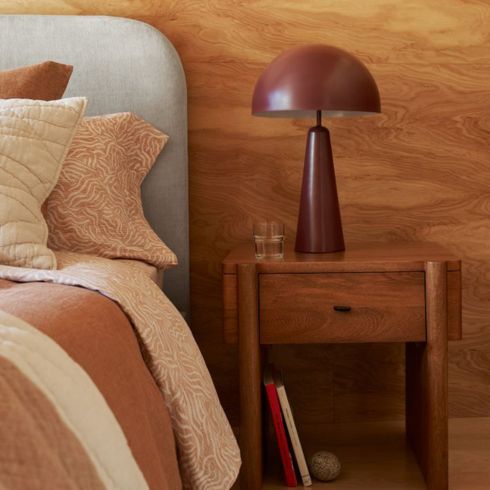 West Elm's Dome Table Lamp alongside a bed
