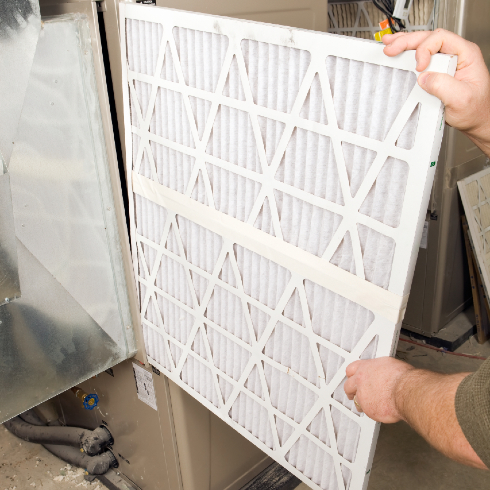 Person removing a furnace filter