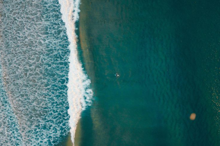 Aerial shot of surfer in ocean