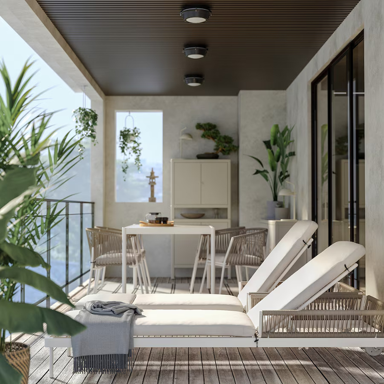 A balcony with white patio furniture from IKEA