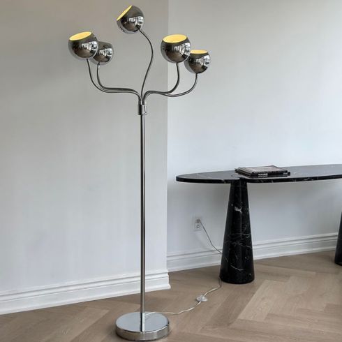 A vintage chrome lamp in a minimalist room
