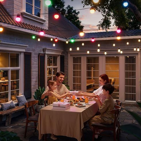 Family eating outside in the patio with colourful LED lights