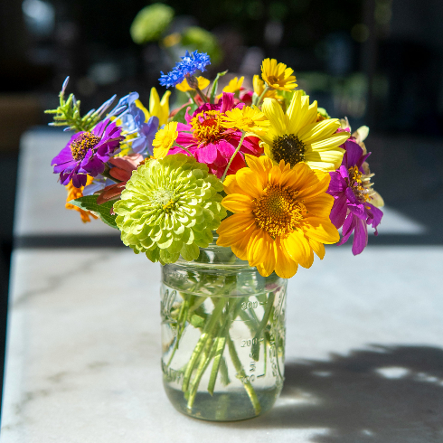 A bright bouquet of wildflowers in a clear vase
