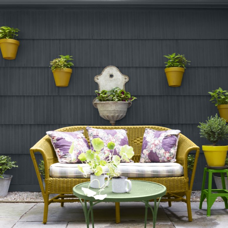 Outdoor sofa with planters on the wall