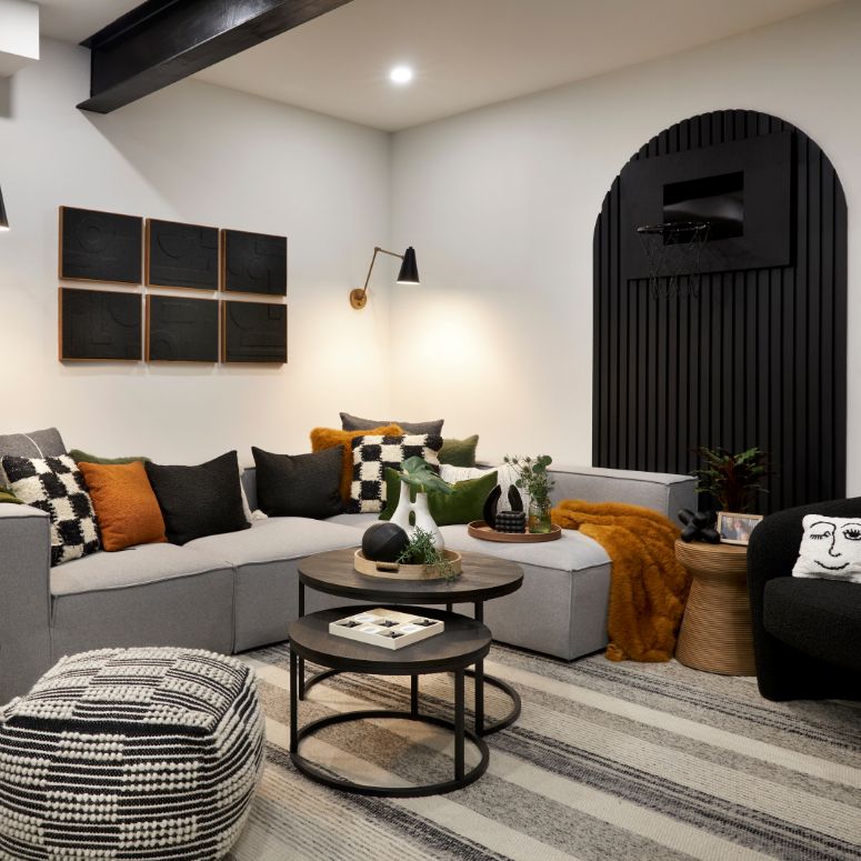 Vibrant living room with grey couch and checkered throw pillows form Styled